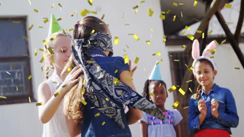 Children Playing Outdoor Party Game with Festive Confetti