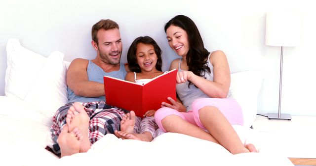 Happy Family Reading Book Together in Bed - Download Free Stock Images Pikwizard.com