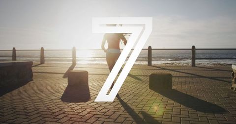 Woman Running on Ocean Promenade with Countdown Overlay