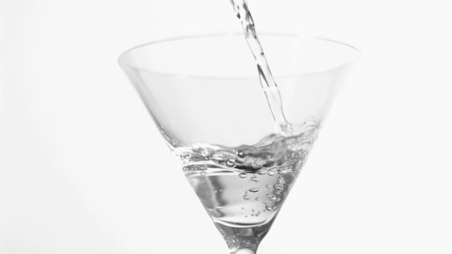 Elegantly capturing an alcoholic drink being poured into a martini glass with attention to the details of splash and liquid flow. This visually engaging video works well for bar promotions, cocktail recipes, beverage industry advertisements, and lifestyle blogs. Its high contrast and clarity emphasize sophisticated theme suitable for marketing and commercial use.