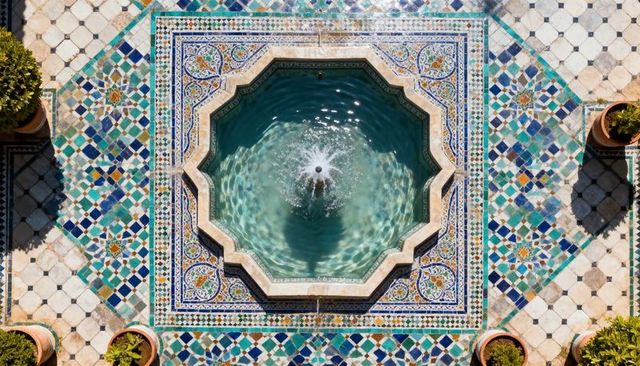 Showcasing ornate octagonal mosaic fountain in sunny courtyard, aerial symmetry