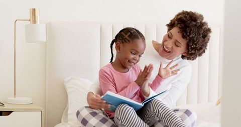 Diverse Mother and Daughter Enjoying Reading Time Together