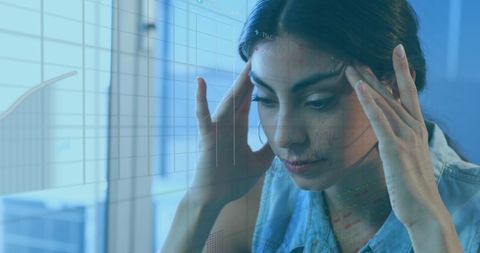 Businesswoman Analyzing Financial Data with Digital Graphs in Office