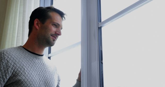 Man Looking Through Window on Overcast Day - Download Free Stock Images Pikwizard.com