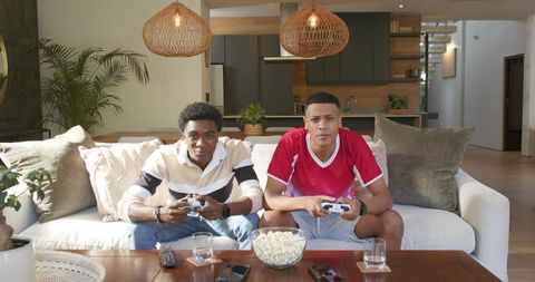 Diverse Friends Playing Video Games in Living Room