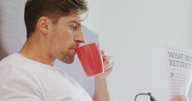 Man Relaxing with Coffee and Reading Newspaper in Bedroom - Download Free Stock Images Pikwizard.com