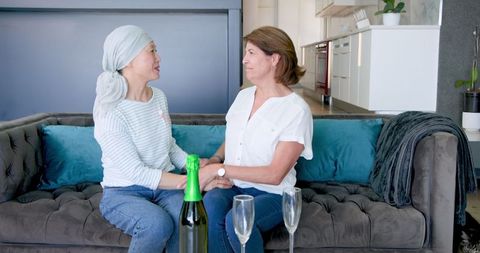 Senior Women Celebrating Friendship with Champagne at Home