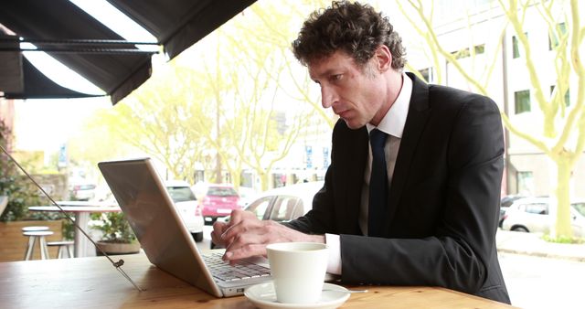 Businessman Working on Laptop at Outdoor Coffee Shop - Download Free Stock Images Pikwizard.com