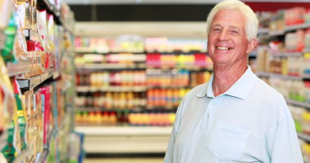 Senior man smiling while shopping in grocery store aisle. This image can be used in marketing materials related to retail, online grocery services, or senior well-being advertisements.
