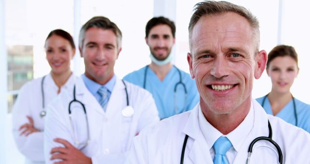 Smiling Senior Doctor Leading Medical Team - Download Free Stock Images Pikwizard.com