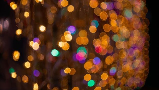 Golden Bokeh Curtain of Multicolor Festive Lights Creating Soft Glowing Orbs Background