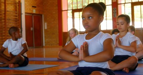 Children Practicing Yoga in School Gymnasium