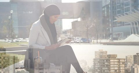 Businesswoman in Hijab Using Tablet in Urban Park