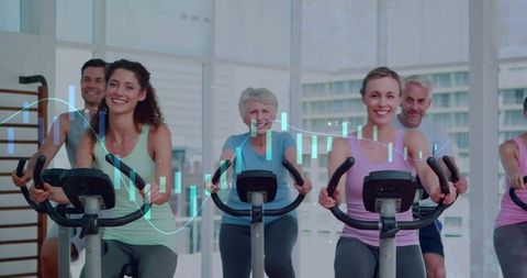 Group indoor cycling class pedaling with fitness analytics overlay in bright urban studio