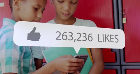 Boys Engaged with Smartphone Displaying Large Social Media Likes