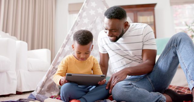 Father and Son Using Digital Tablet in Cozy Living Room - Download Free Stock Images Pikwizard.com