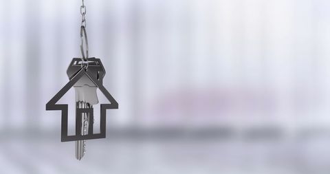 House shaped keychain symbolizing real estate ownership