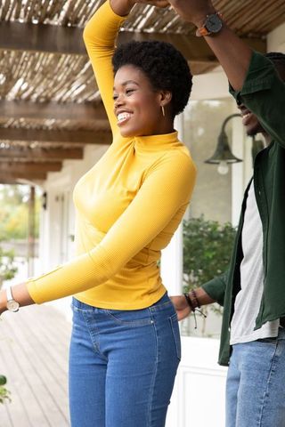 Joyful Couple Dancing Together on Cozy Porch
