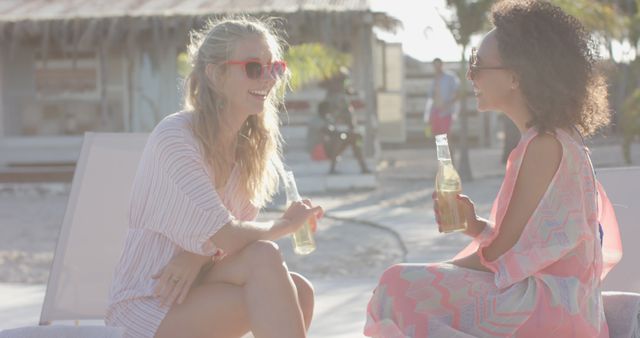 Two Women Enjoying Drinks at Beach Resort - Download Free Stock Images Pikwizard.com