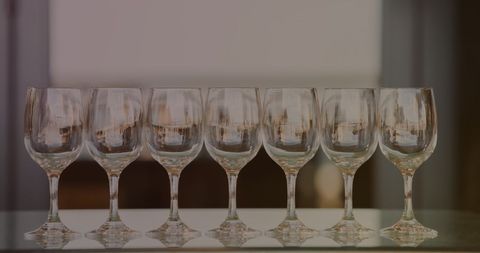 Seven Empty Wine Glasses with Golden Reflections Eliciting Elegance and Sophistication - Download Free Stock Images Pikwizard.com