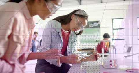 High school students conducting hands-on science experiment with pipette and test tubes