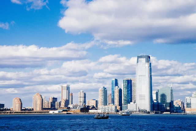 Sunny Skyline of Manhattan with Cloudy Sky and Blue Waters - Download Free Stock Photos Pikwizard.com