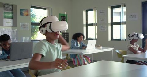 African students exploring virtual reality in classroom with laptops and collaboration