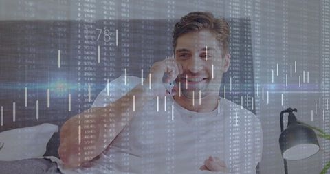 Smiling man holding smartphone in bed while trading stocks with candlestick data overlay