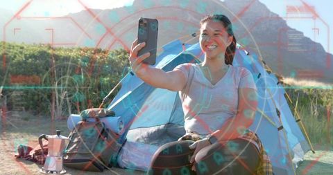 Smiling Woman Taking Selfie at Campsite with Tech Twist