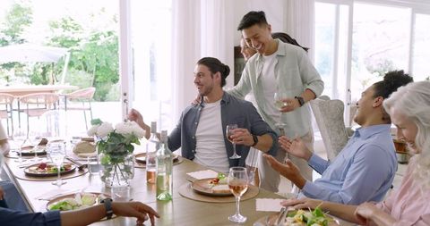 Friends Socializing and Toasting During Casual Celebration Dinner