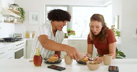 Couple Enjoying Breakfast with Pancakes in Sunny Kitchen