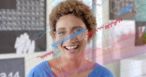 Smiling professional presenting financial analytics with chart overlays in home office