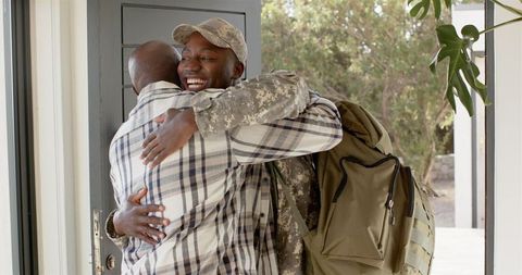 Emotional Reunion of Military Soldier and Family Member at Home