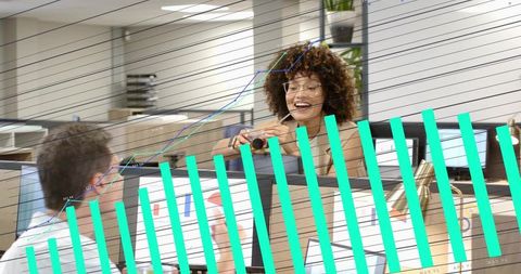 Smiling coworker leaning over cubicle handing tape dispenser, collaborative office teamwork moment