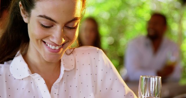 Smiling Woman Enjoying Drink Outdoors in Sunlight - Download Free Stock Images Pikwizard.com