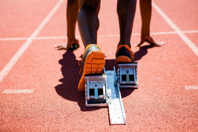 Close-up of feet of an athlete on a starting block about to run