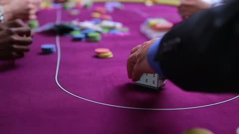 Man Playing High-Stakes Poker in Casino Setting