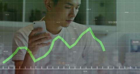Asian businessman analyzing stock market data on smartphone