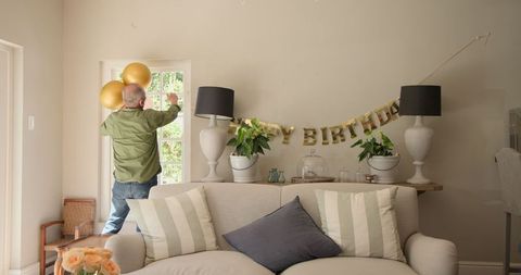 Preparing living room for birthday celebration with decorations