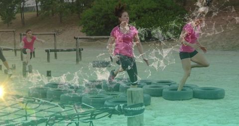 Women Overcoming Obstacles With Energy Outdoor Training Course