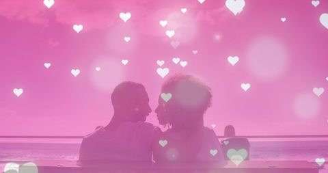 Romantic Couple Embracing at Scenic Beach with Hearts Overlay