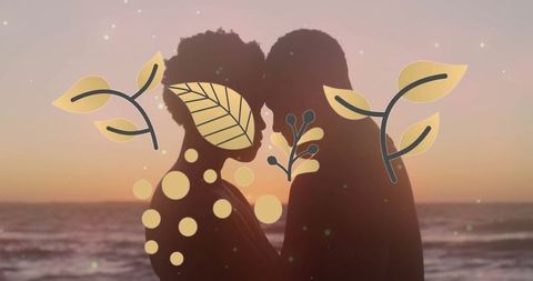 Romantic silhouette of couple with leaf motifs at beach during sunset