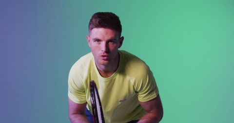 Male Tennis Player in Action with Bright Lighting