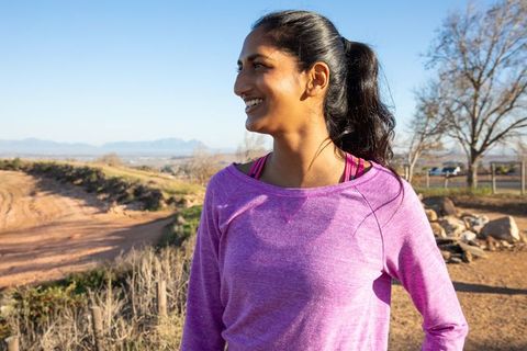 Woman Enjoying Outdoor Fitness Adventure on Scenic Dirt Trail