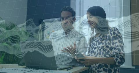 Reviewing analytics on laptop and smartphone, colleagues collaborating with dynamic data overlay