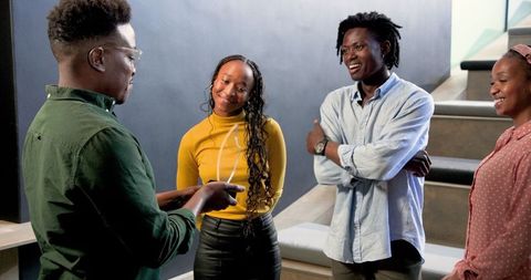 Diverse Team Engaging in a Fun Office Meeting
