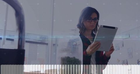 Female Scientist Analyzing Research Data on Tablet in Modern Laboratory