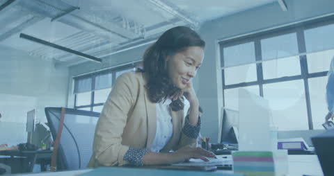 Smiling Professional Engages with Technology in Modern Office