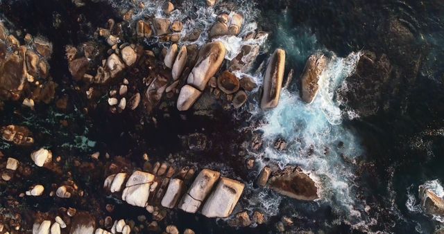 Drone view of clear green ocean water and rocks with copy space. Exploration, travel, coast, tranquillity and nature concept.