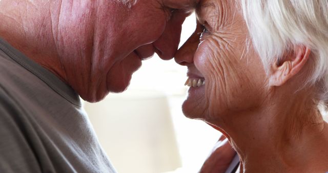 Happy senior couple romancing in bedroom at home - Download Free Stock Photos Pikwizard.com